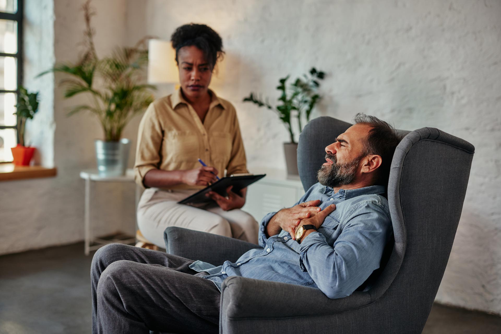 caring-counselor-listening-to-male-patient